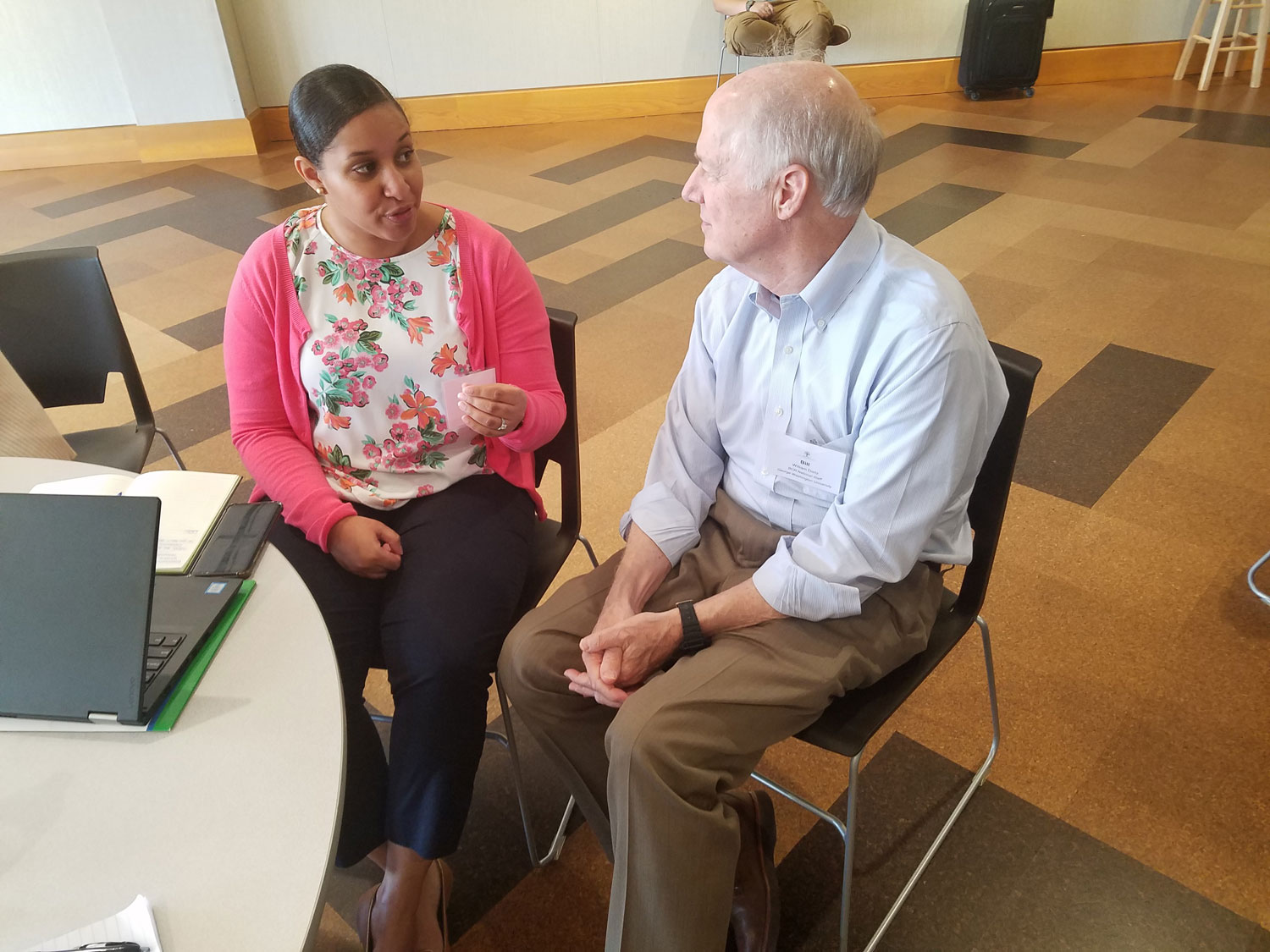 Two people talk at conference