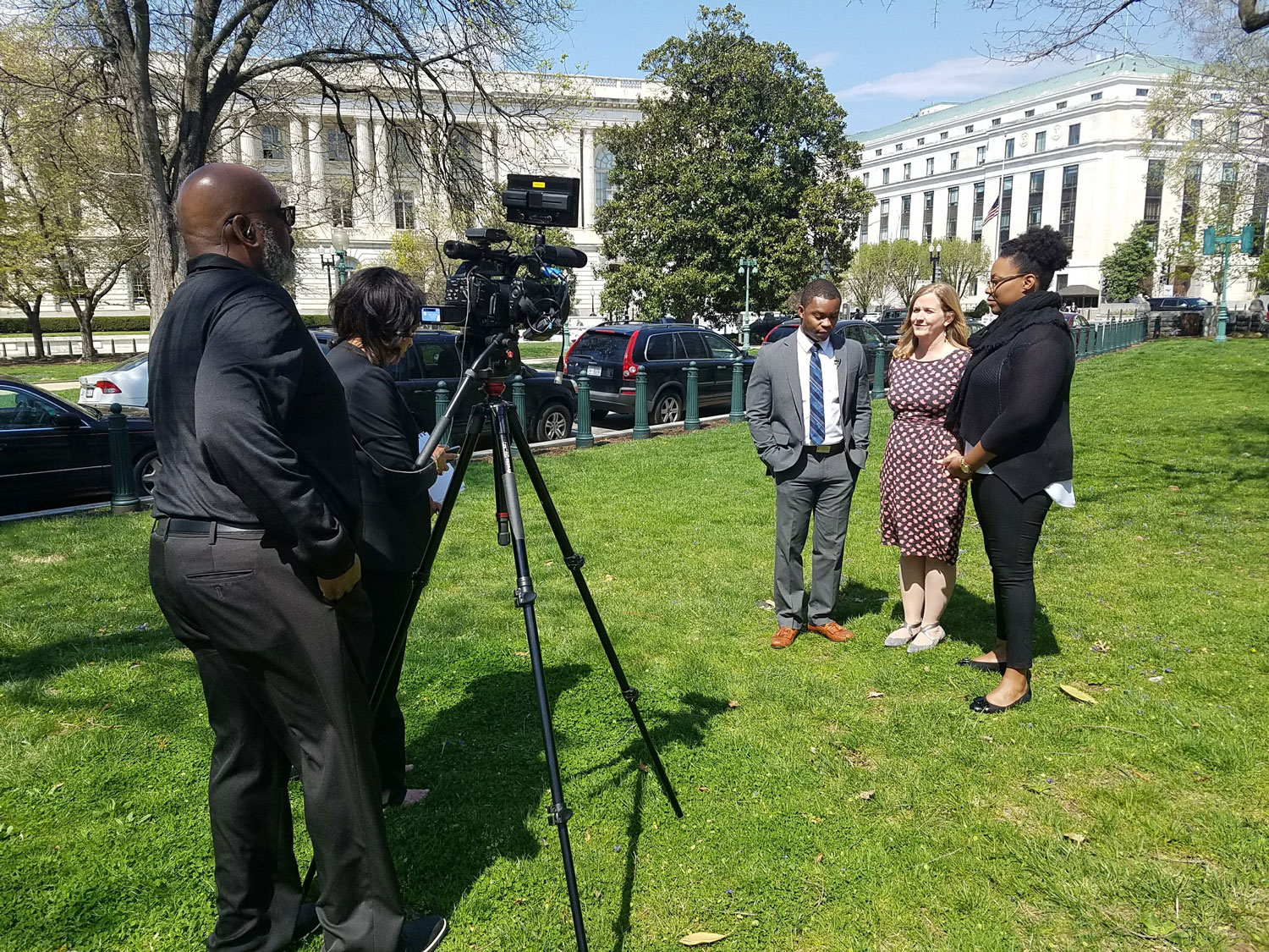 Team MoKan Three people stand in front of news crew