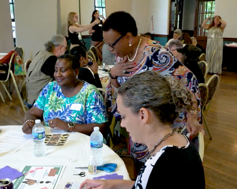 kathy-wade-at-sq-conversation African American woman looks at quilting table