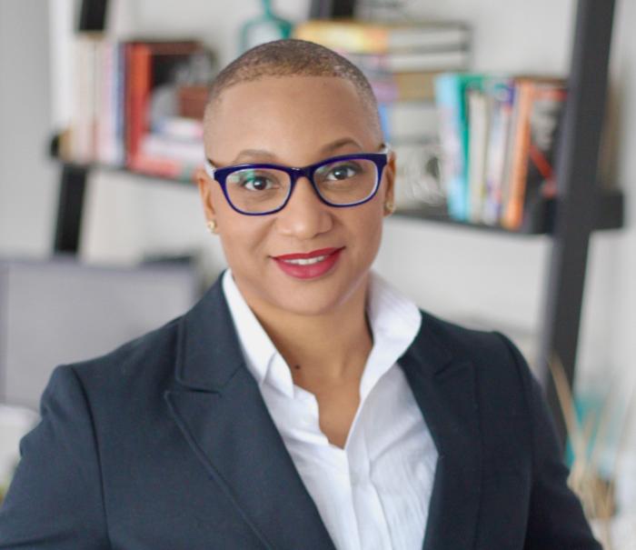Headshot of Tia Sheree Gaynor, PhD - black woman with a short haircut, glasses, white collared shirt and black blazer